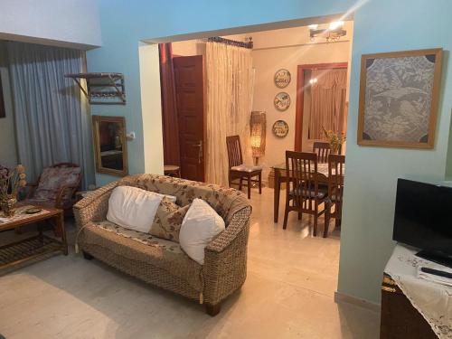 a living room with a couch and a dining room at Hliannas house in EFL