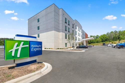 a building with a sign in front of a parking lot at Holiday Inn Express Asheville Woodfin by IHG in Asheville