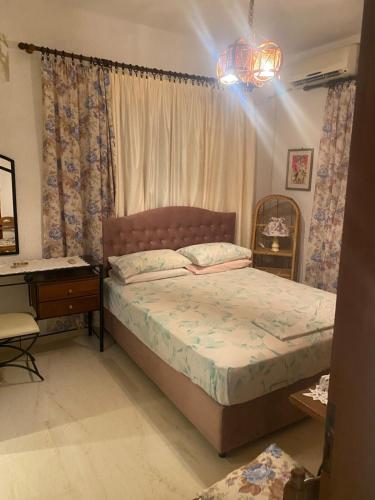 a bedroom with a bed and a desk and a window at Hliannas house in EFL