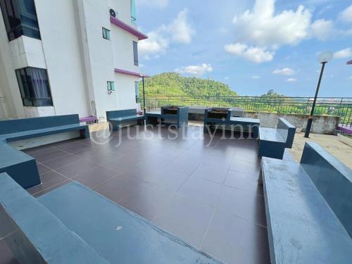 a view from the balcony of a building with benches at Just Stay-Inn Guesthouse The Heights Residence Melaka in Ayer Keroh