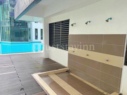 a room with a large window in a building at Just Stay-Inn Guesthouse The Heights Residence Melaka in Ayer Keroh