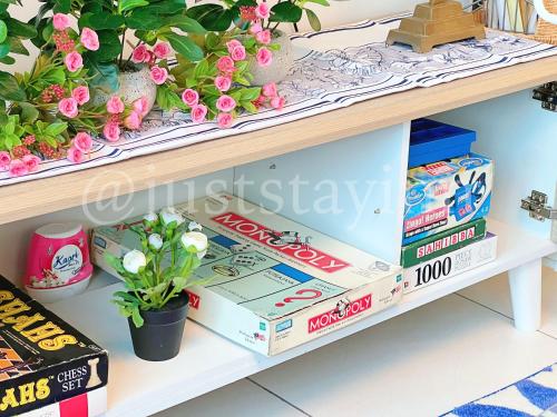 a shelf with some plants and boxes of food at Just Stay-Inn Guesthouse The Heights Residence Melaka in Ayer Keroh