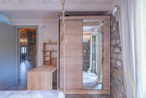 a room with a glass door leading into a bedroom at PIETRA VILLA Akoli beach in Rodhodháfni