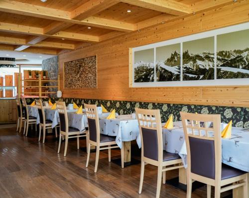 a dining room with blue tables and chairs at Hotel Chalet Dlaces in Selva di Val Gardena
