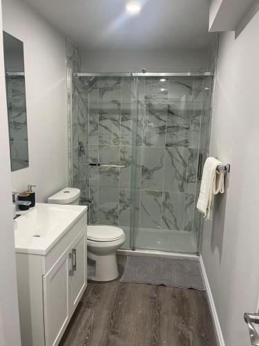 a bathroom with a shower and a toilet and a sink at The Place in Winnipeg