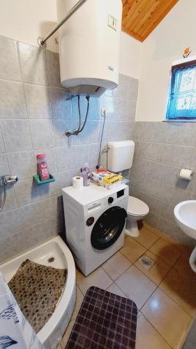a bathroom with a toilet and a sink at Holiday house in Pula