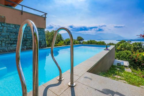 a swimming pool with two metal rails next to a building at Casa Bella Vista in Laveno