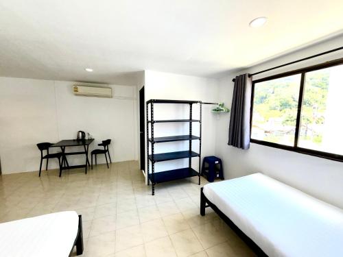 a room with a room with a table and a bed at Patong Canal Villa R306 in Patong Beach