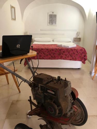 a motorcycle parked in front of a bed with a laptop at La piccola casa di Tania in via Fieramosca in Terlizzi