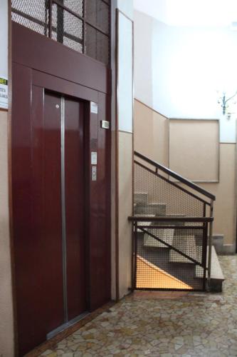 an entrance to a building with a red door at Henry's House in Parma