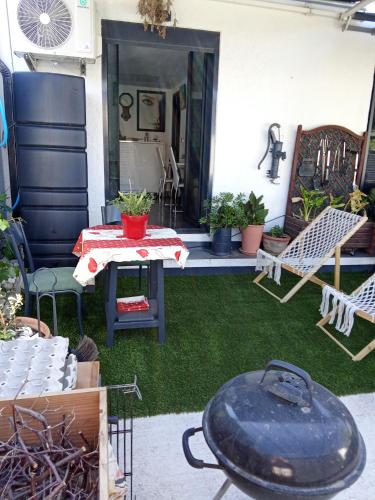 a patio with a table and chairs and a grill at STUDIO Perpignan in Perpignan