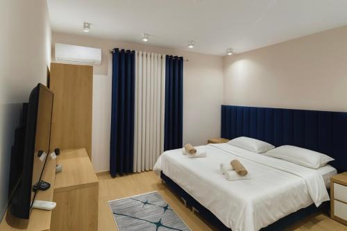 a bedroom with a large bed with two towels on it at Hotel Krial in Berat