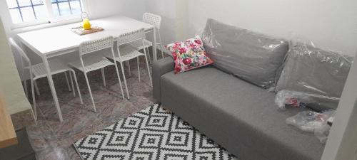 a living room with a couch and a table at A Beautiful Townhouse in Rute