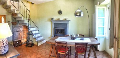 a dining room with a table and a fireplace at Villa Le Giare in Vignone