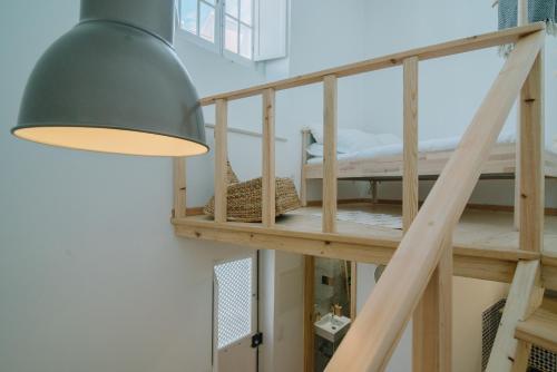 a room with a bunk bed and a lamp at Loft 11 in Olhão