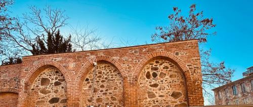 a brick wall with two arches on top of it at Schlosswache21 in Zerbst
