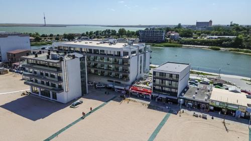 an aerial view of a building next to a body of water at Miraky Beach in Văleni