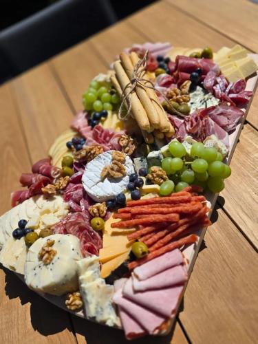 a plate of different types of food on a table at Świerkowe Chatki w Koniakowie in Koniaków