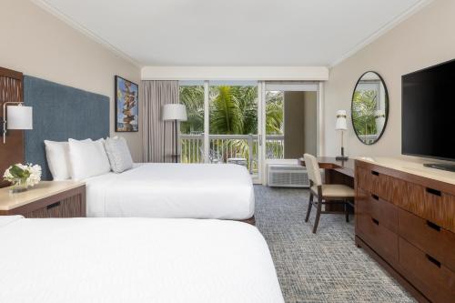a hotel room with two beds and a television at Opal Key Resort & Marina in Key West
