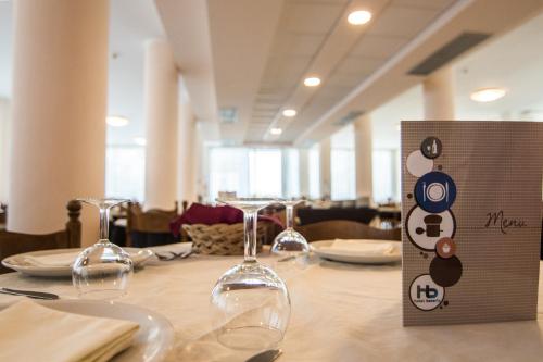 a table with wine glasses sitting on top of it at Hotel Beverly in Rimini