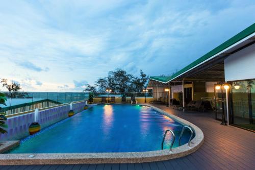 a swimming pool on the roof of a hotel at Anda Beachside Hotel in Karon Beach