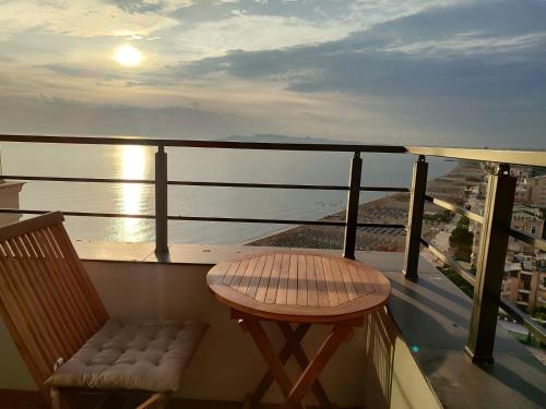 a balcony with a chair and a view of the ocean at Beachfront Marilyn in Durrës