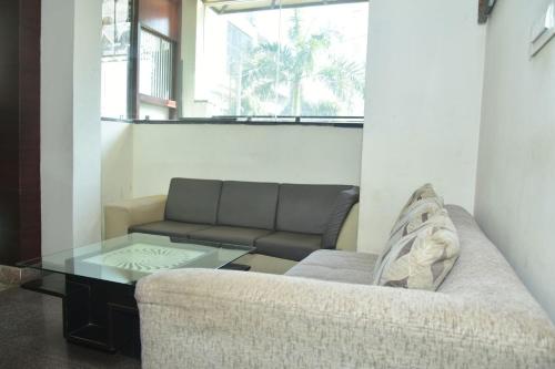 a living room with a couch and a glass table at Hotel Azure in Varanasi
