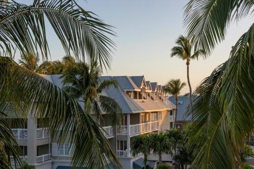 a large building with palm trees in front of it at Opal Key Resort & Marina in Key West
