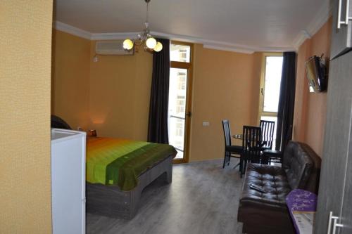 a bedroom with a bed and a living room with a couch at orbi plaza in Batumi