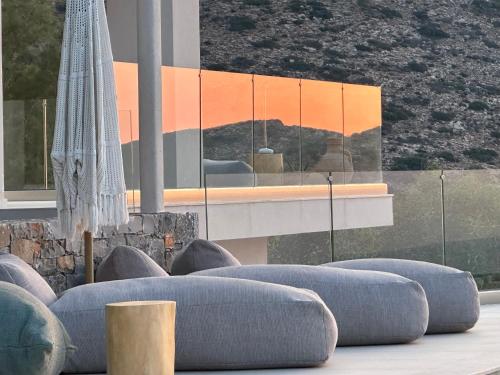 a room with blue couches in front of a building at Maison Meltem in Agia Pelagia