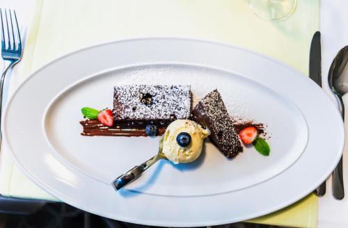 a white plate with chocolate desserts on a table at Wellness Hotel Panorama in Trenčianske Teplice