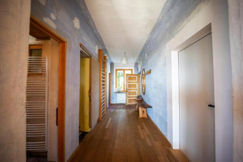 a hallway with blue walls and a door at ELIAS Residency in Rob
