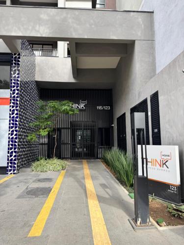 an entrance to a building with a sign in front of it at Modern studio in Santa Cecilia in Sao Paulo