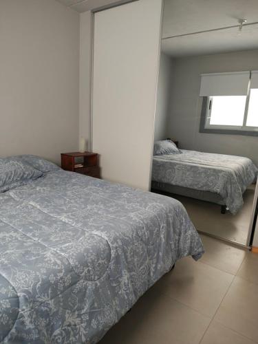 a bedroom with two beds and a mirror at Portales de Tupungato in Tupungato