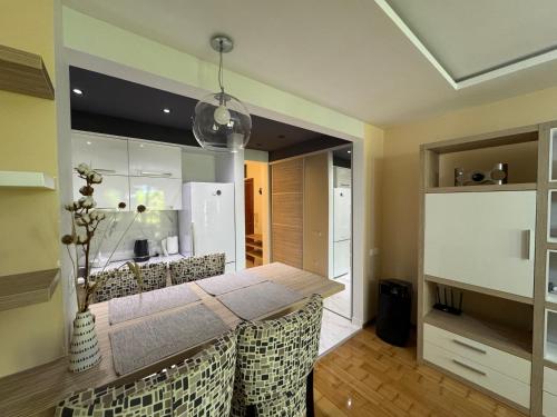 a kitchen with a dining room table and a refrigerator at Comfortable family apartments in Przno in Pržno