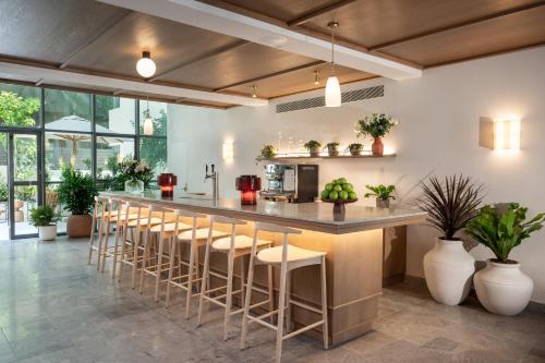 a kitchen with a large counter with stools at master Mazeh in Tel Aviv