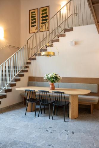 a dining room with a table and a staircase at master Mazeh in Tel Aviv