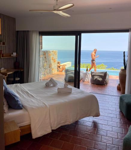 a bedroom with a bed and a view of the ocean at Maison Meltem in Agia Pelagia