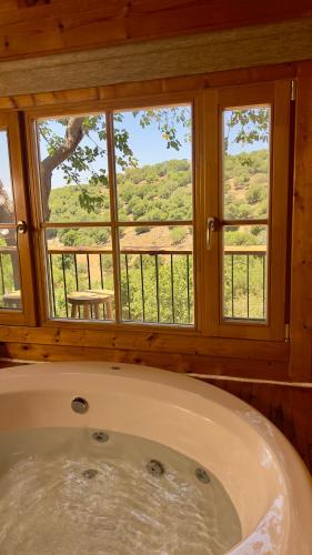 a bath tub in a room with a window at פסגת מתת Pisgat mattat in Mattat