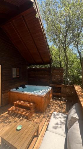 a wooden cabin with a bed on a deck at פסגת מתת Pisgat mattat in Mattat