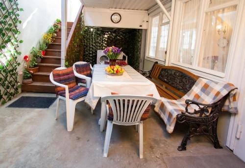 a patio with a table and chairs and stairs at Cozy House And Yard Old Tbilisi Center in Tbilisi City