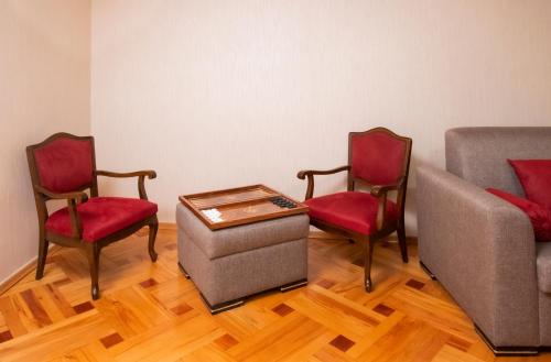a room with two chairs and a table and a couch at Cozy House And Yard Old Tbilisi Center in Tbilisi City