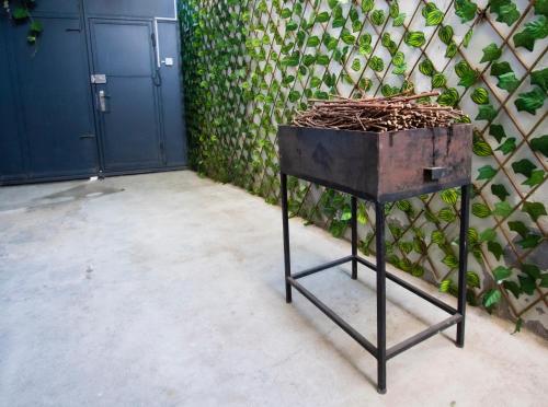 a metal grill sitting in front of a wall at Cozy House And Yard Old Tbilisi Center in Tbilisi City
