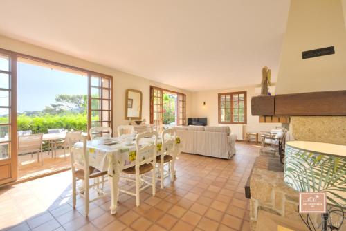 a large living room with a table and chairs at Maison de la Rade, sea view and air conditioning in Saint-Mandrier-sur-Mer