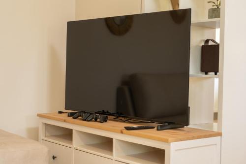 a flat screen tv sitting on top of a table at Melitini's Villa in Argostoli