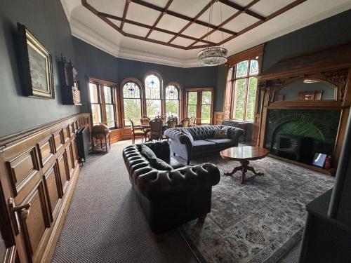 a living room with a couch and a fireplace at The Royal Tay Apartment in Dundee
