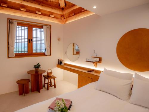a bedroom with a bed and a desk at Hanok Stay Yeoyeo in Gyeongju
