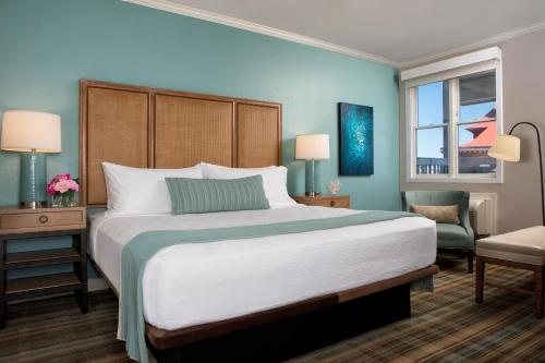 a hotel room with a large bed and a chair at Opal Key Resort & Marina in Key West