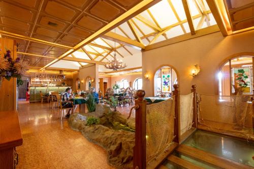 a large room with a large aquarium in a building at Hotel resort Lovecká bašta Strakonice in Strakonice