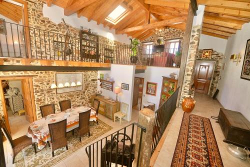 a large living room with a stone wall at Riverside - Lovely river-view 3 bedroom house in Dornes